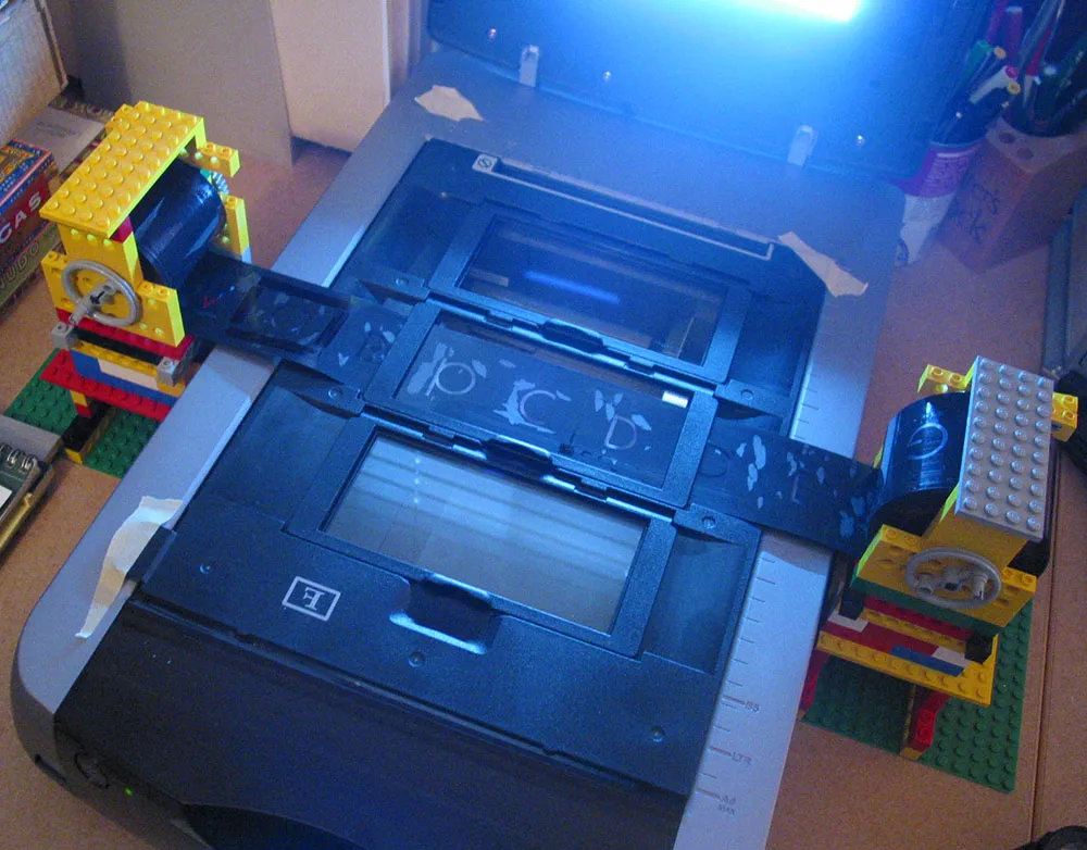 Scanner set up to scan a film font using a feed system constructed of Legos